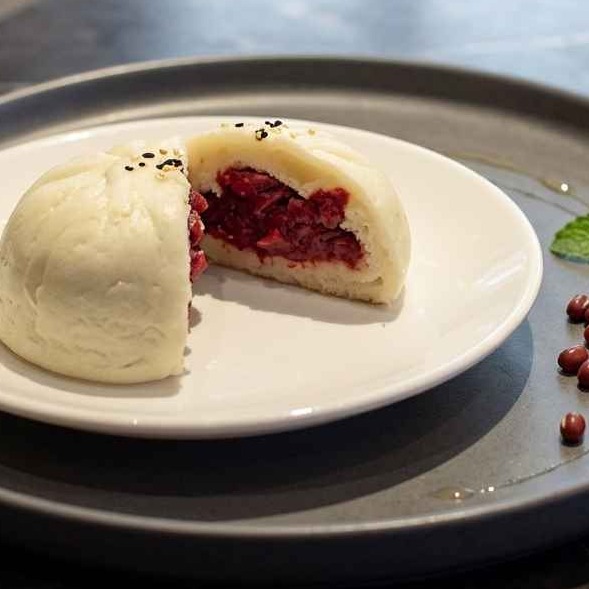 Soft steamed buns filled with sweet red bean paste.